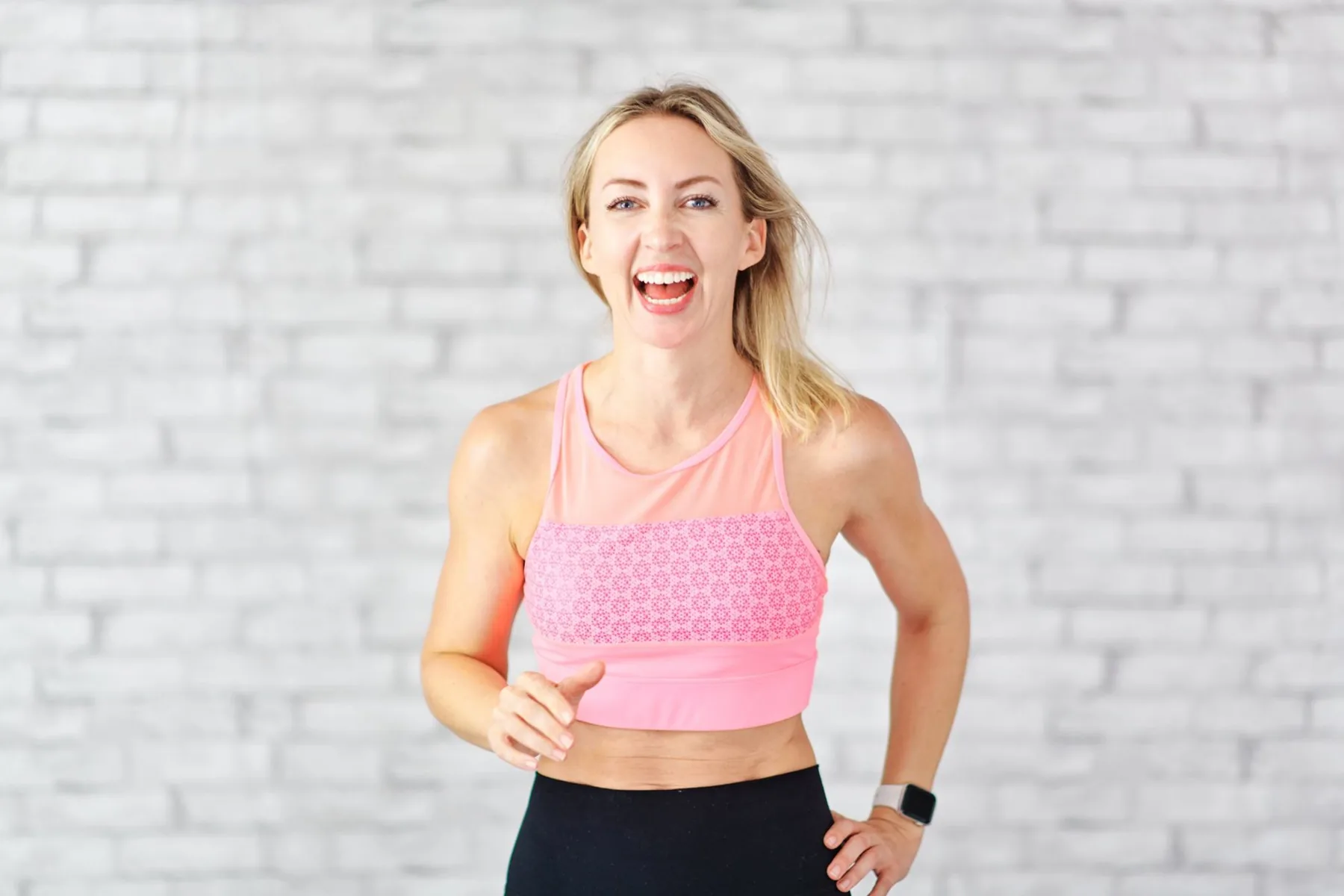 Emma Bromley laughing in a pink sports top