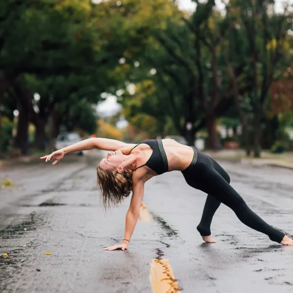 Emma in a wild thing pose on a wet street