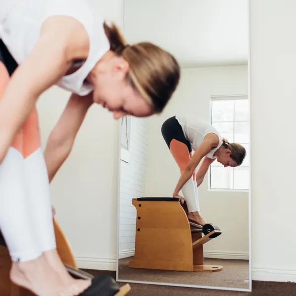 Emma on the Pilates chair in her studio