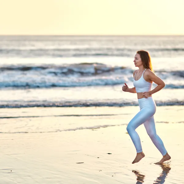 Emma running on the beach at sunset