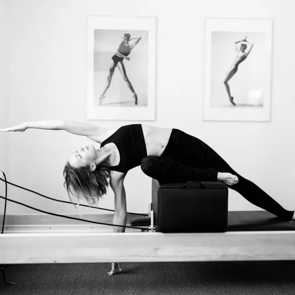 Emma stretching on the reformer