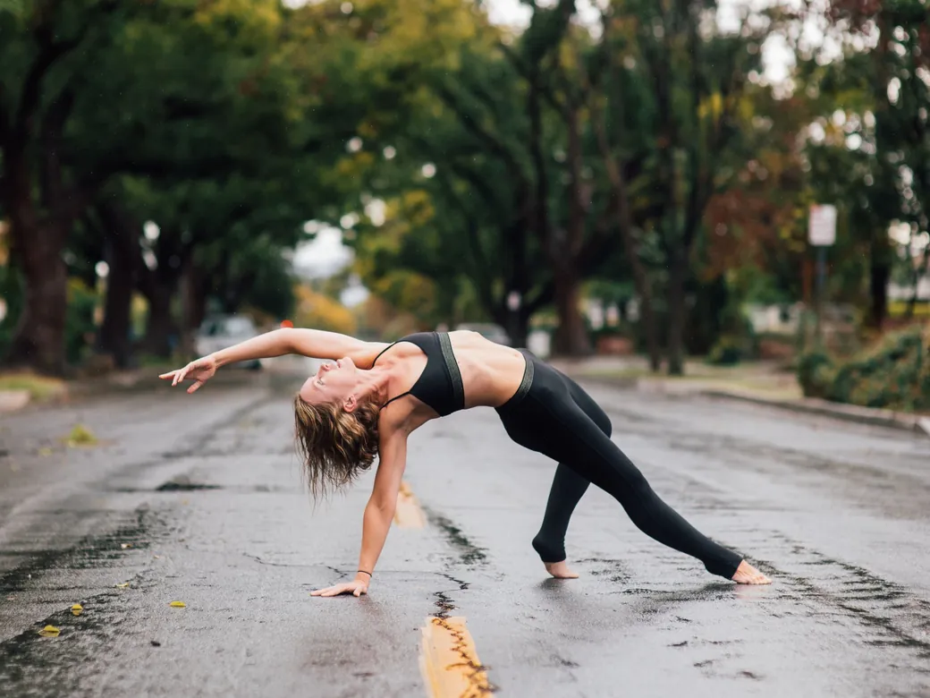 Emma in a wild thing stretch on a wet street