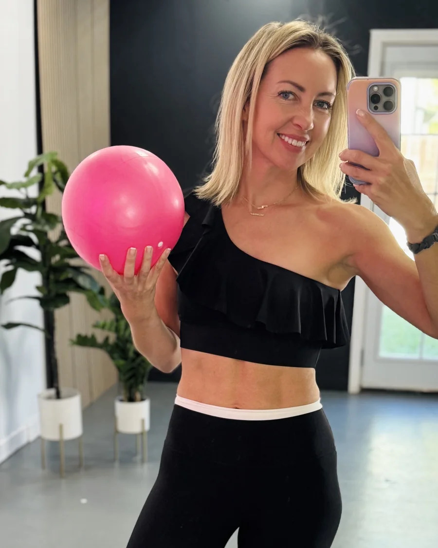 Emma holding a pink ball in her studio