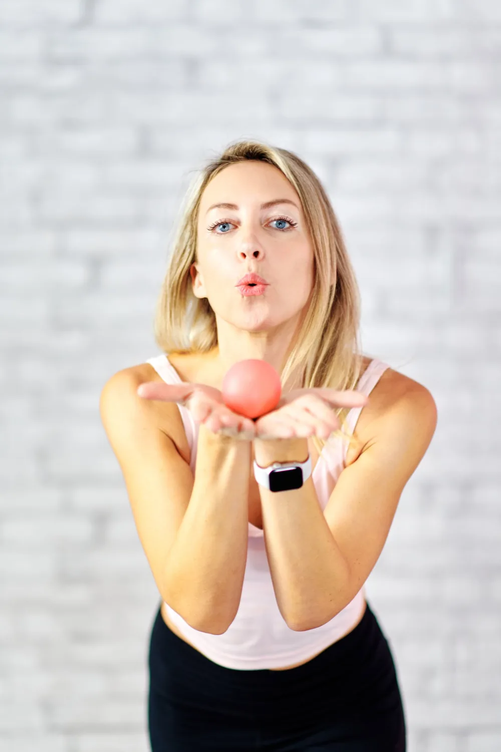 Emma blowing a kiss, holding a small ball